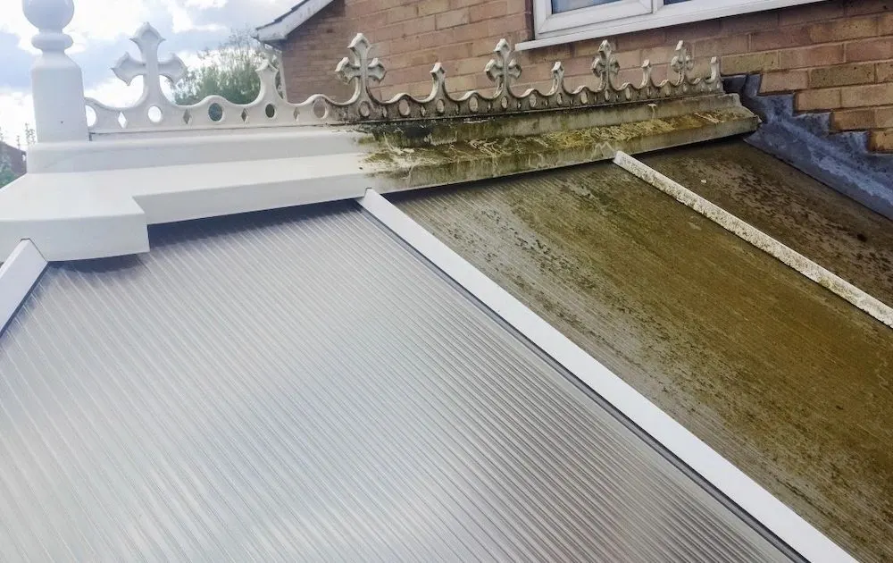 Conservatory roof part cleaned, clean on one side and green on the other